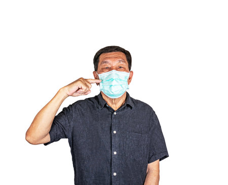 Asian Senior man pointing at the face mask, isolated on white backgroundの写真素材