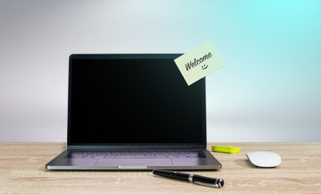 Welcome on sticky note with computer laptop on deskの写真素材