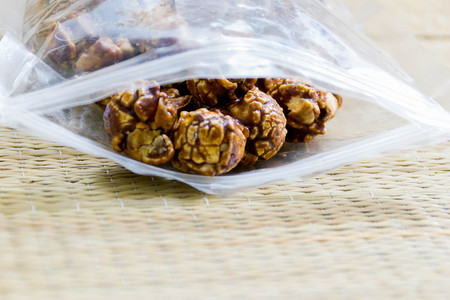 Chocolate covered popcorn in a clear plastic bag.の写真素材