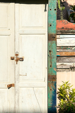 An old closed rustic wooden front door with a rusty lockの写真素材