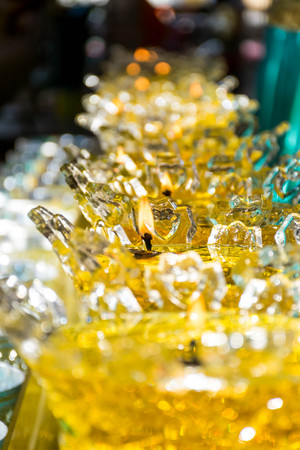 Light of fire in oil lamps Buddhism in Thailand (selective forcus)の写真素材