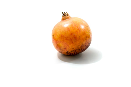 Whole pomegranate isolated on white backgroundの写真素材