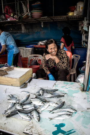 Songkhla, Thailand Apr. 20, 2018 : Portrait of Old female selling Freshs fish in the  the wet market at Hatyai, Songkhla, Thailand.のeditorial素材