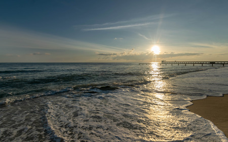 Old bridge  into the sea at sunrise time.の写真素材