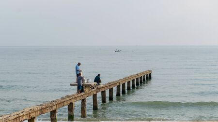 Songkhla, Thailand, Dec 26, 2018 : A Fisherman  waiting to catch the fish on the bridge.のeditorial素材