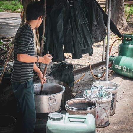 Songkhla, Thailand, May 1, 2018 : Unknown men dying fabrics using ancient methods. Near HatYai Railway Station, Hatyai, Sonkhla, Thailand.のeditorial素材