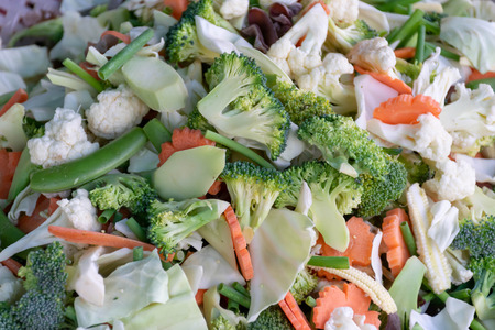 Many kinds of fresh vegetables, mixed together for sale in the market.の写真素材