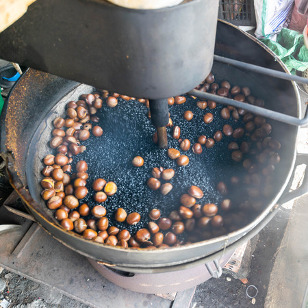 Chestnuts roasted in a large saucepan take photo by slowspeed shutter technic (Motion Background)の写真素材