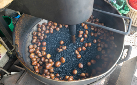 Chestnuts roasted in a large saucepan take photo by slowspeed shutter technic (Motion Background)の写真素材