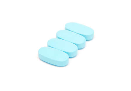 blue pills, capsules, tablets on white