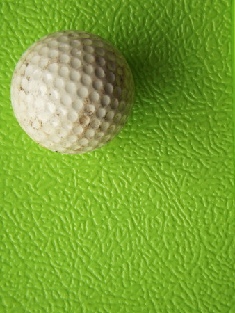 Golf ball past usage. On rough green backgroundの写真素材