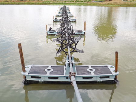 shrimp farming waterwheel,  floating still on water surface in a farm