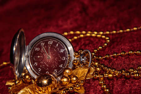 Christmas still life with pocket watch on Burgundy backgroundの写真素材