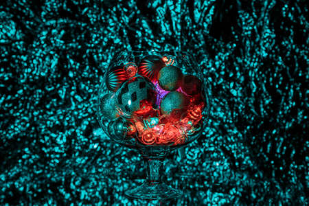 Decorative vase with cut in the form of stars on the background light Christmas garlandの写真素材