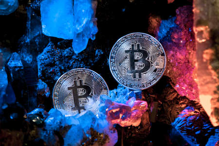 Silver bitcoin in a cave of gem stonesの写真素材