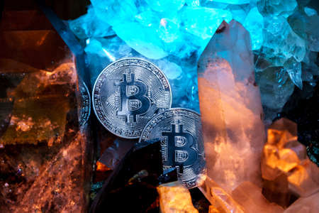 Silver bitcoin in a cave of gem stonesの写真素材