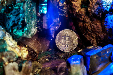 Golden bitcoin in a cave of gem stonesの写真素材