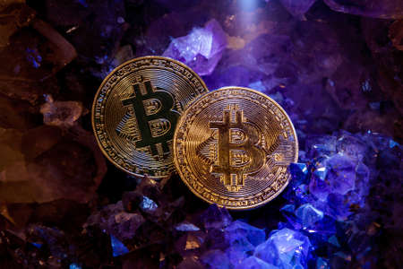 Silver and golden bitcoin in a cave of precious stones. Bitcoin cryptocurrency.の写真素材
