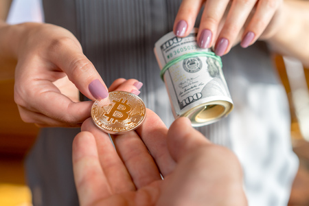 buying dollars hands give dollars and hands give bitcoinの写真素材