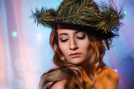 Beautiful forest fairy hat with pine branches. On a festive Christmas background.の写真素材