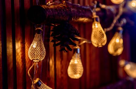 Glow garland on wood background with branchesの写真素材