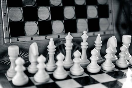 White chess pieces on on the background of a chessboardの写真素材