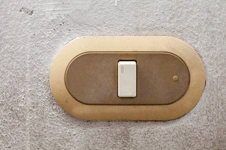 Old dirty switch on the white wallの写真素材