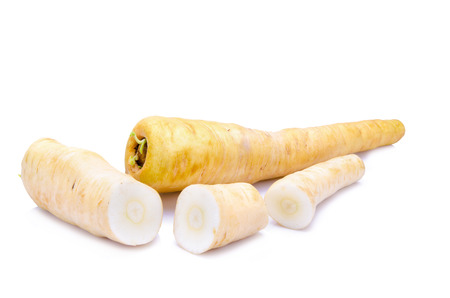Fresh parsnip roots on a white backgroundの写真素材