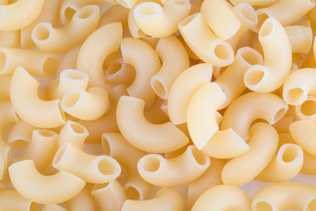 Macaroni pasta close up isolated on whiteの写真素材
