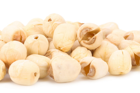 Dried lotus seeds on white background.の写真素材
