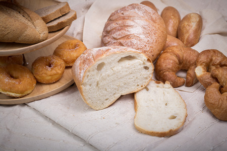 Fresh homemade bread in a cotton cloth background.