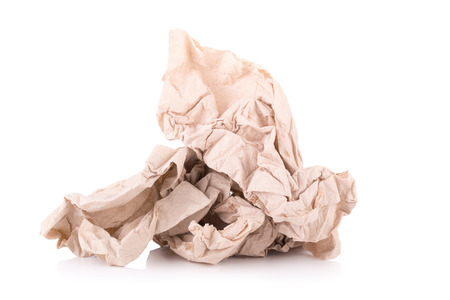 Used screwed brown paper tissue isolated on white background.の写真素材