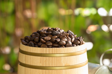 Roasted coffee beans on a wood floor for decoration.の写真素材