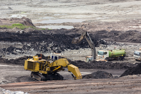 yellow backhoe work in coalmine.