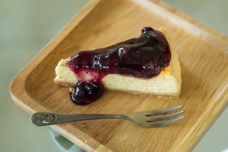 Blueberry cheesecake on wooden plate.の写真素材