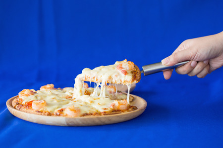 Delicious pizza with seafood bule background.の写真素材