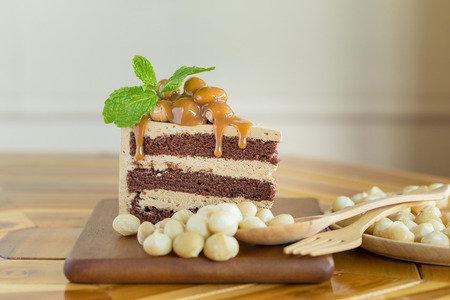 Macadamia cake and macadamia nut on wooden plate.の写真素材