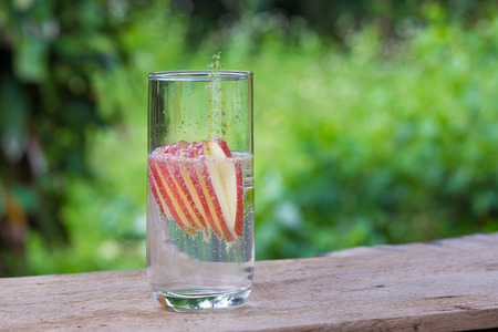 Detox water with apples on table.の写真素材