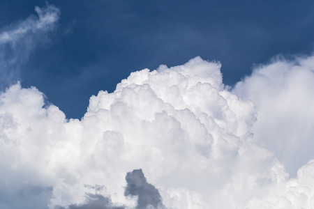 Blue sky with some white puffy cloudsの写真素材