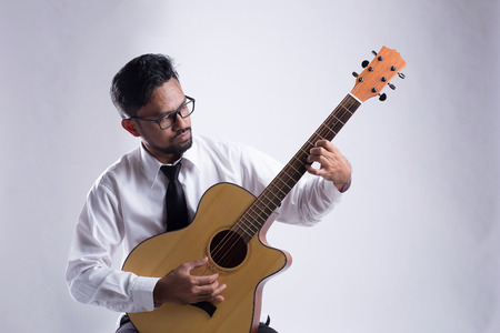 Studio portrait of senior man playing guitarの写真素材