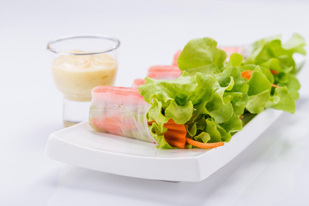 Fresh vegetable salad roll in noodle tube isolated on white backgroundの写真素材