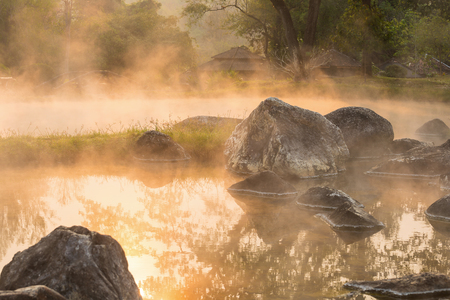 Sun reflecing on the Hot spring at national park during sunrise Thailandの写真素材