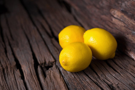 Fresh ripe lemons on Dark vintage wood texture background.の写真素材