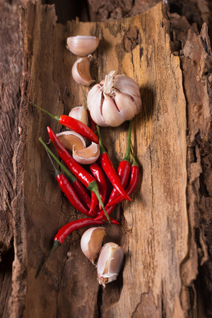 Red hot chili peppers And garlic on wooden background. Spicy chilli peppers.の写真素材