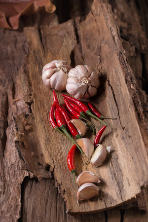 Red hot chili peppers And garlic on wooden background. Spicy chilli peppers.の写真素材