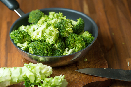 Healthy Green Organic Raw Broccoli Florets Ready for Cooking. Broccoli.Raw fresh broccoli on wooden table.の写真素材