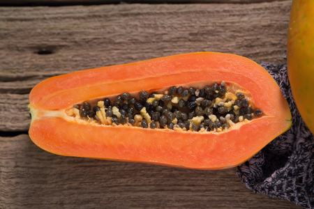 Papaya on wooden background. Sliced of papaya. Ripe papaya.の写真素材