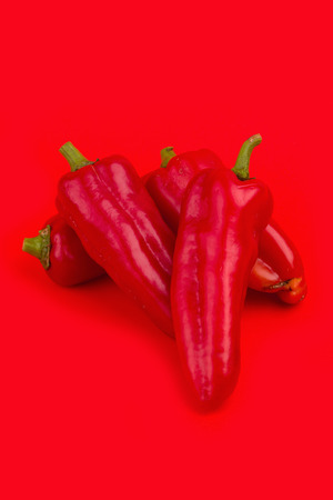 red chilli vegetable Isolated on red background.の写真素材