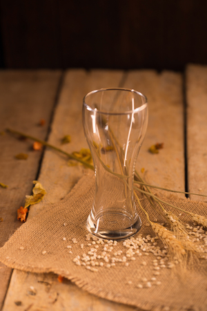 Empty glass of beer on wooden stand.の写真素材