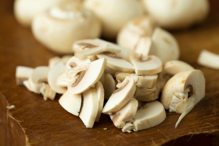 Champignon mushrooms on the wooden table. Selective focus.の写真素材